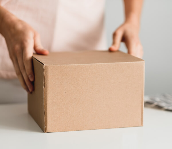 woman-holding-a-cardboard-box-the-parcel-in-hands-2023-11-27-05-33-45-utc 1 (1)